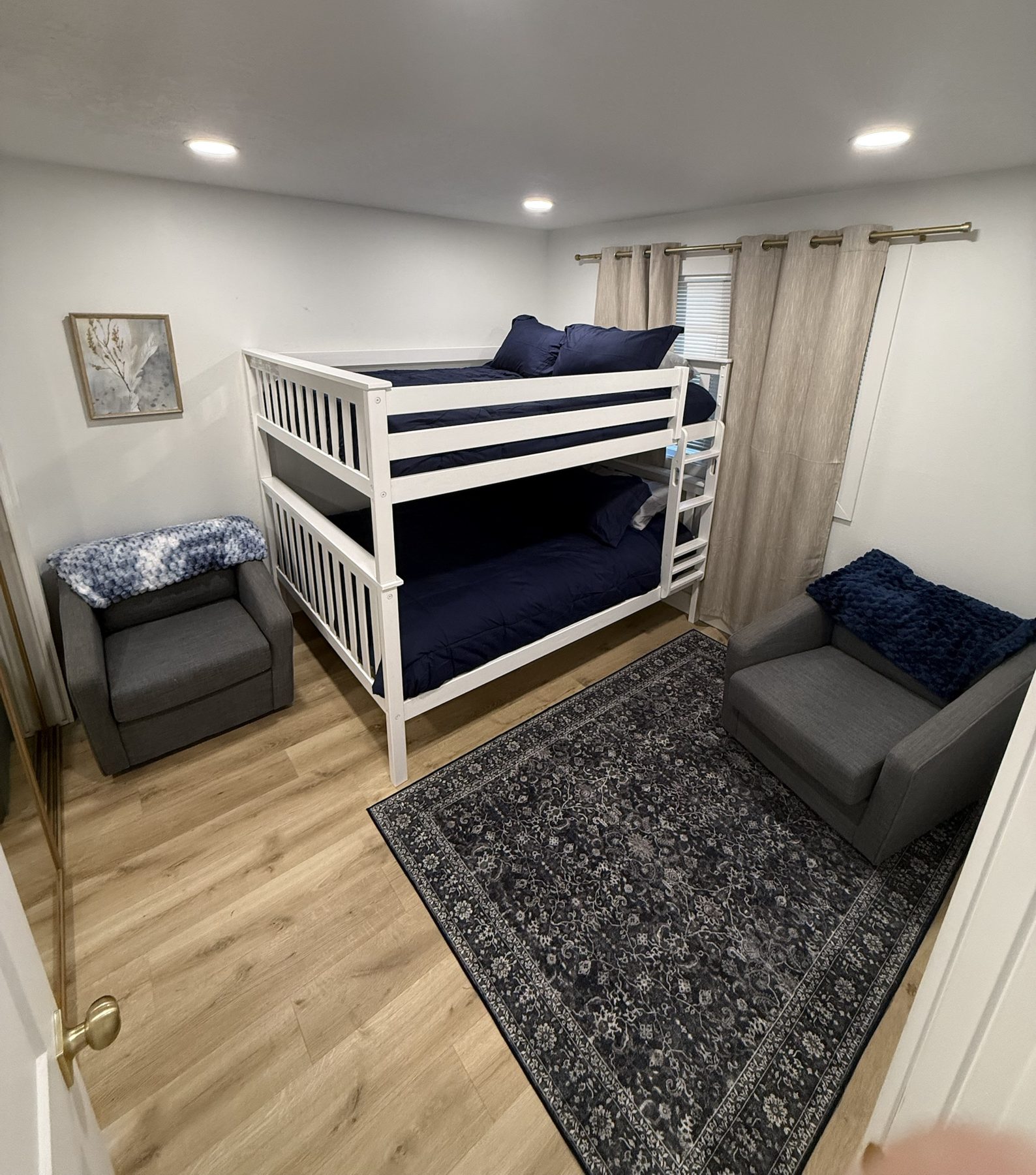 Bunk bedroom with two armchairs